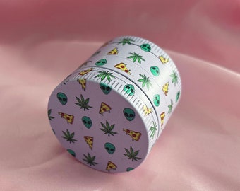 Happy Buds Small Grinder in Pink with alien, leaf and pizza motifs