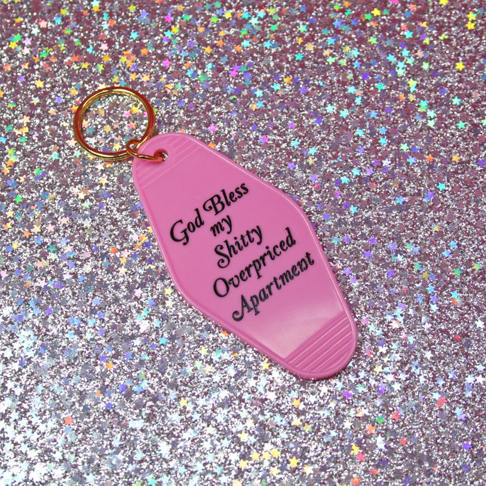 A Shop of Things God Bless my Shitty Apartment keychain PINK