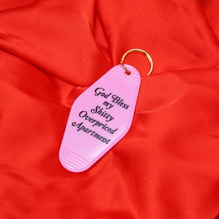 A Shop of Things God Bless my Shitty Apartment keychain PINK